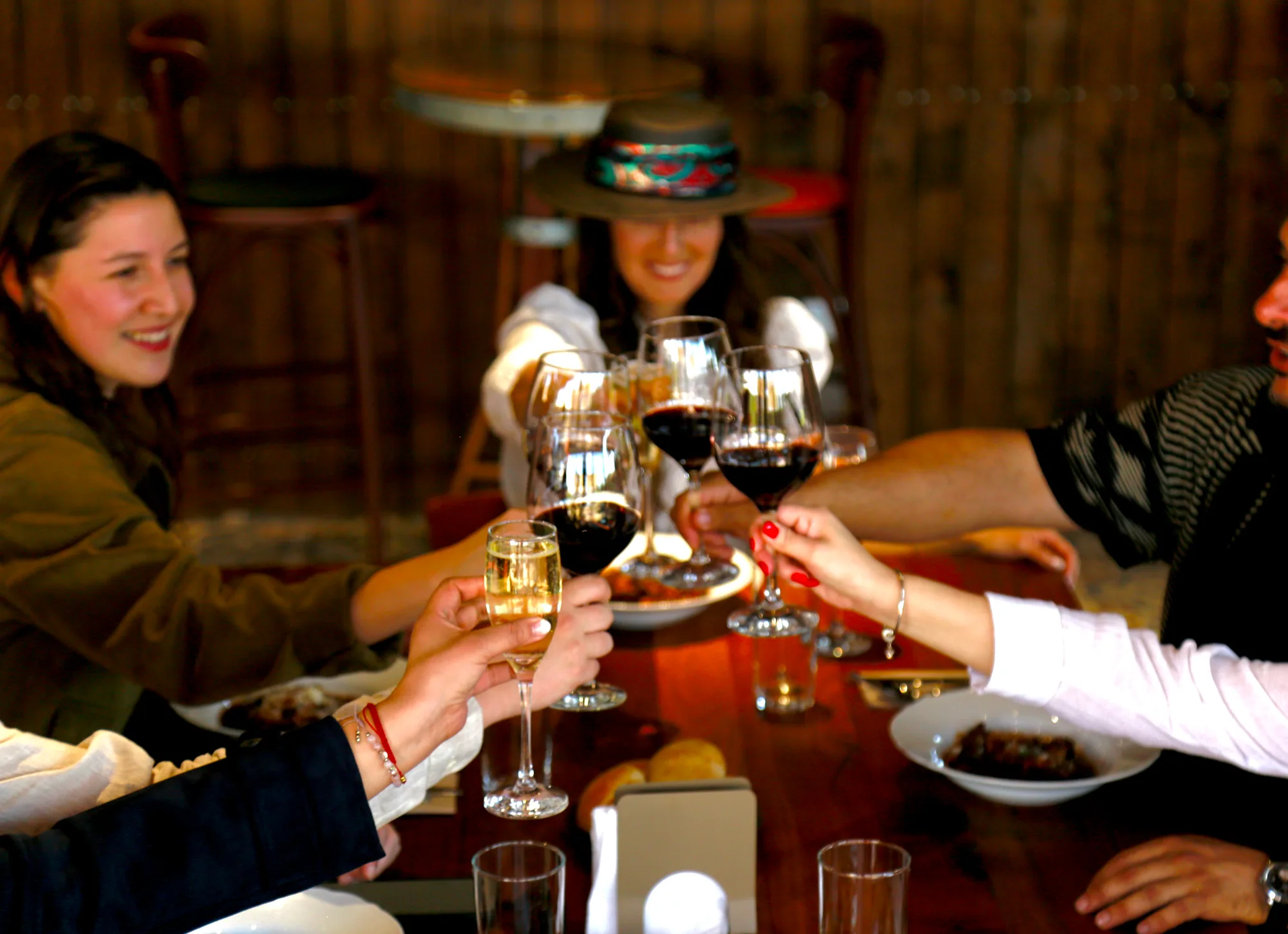Glasses of wine and sparkling wine clinking together in a toast