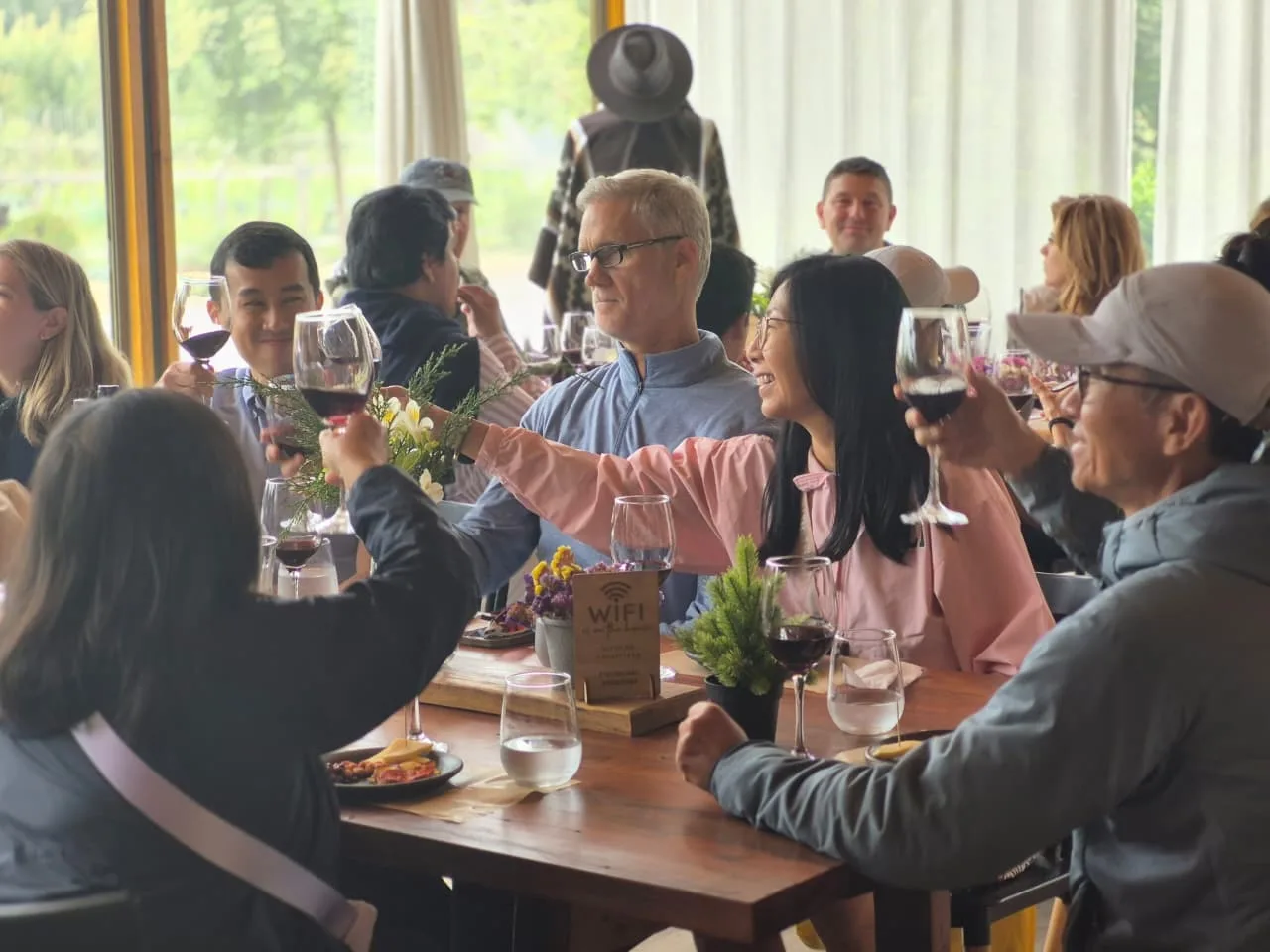 Guests raising a toast together at the long table